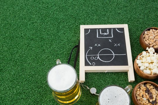 Strategy board, football and snacks on artificial grass - Powered by Adobe