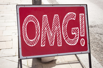 Obraz premium Conceptual hand writing text caption inspiration showing OMG Oh My God. Business concept for Surprise Humor written on announcement road sign with background and copy space