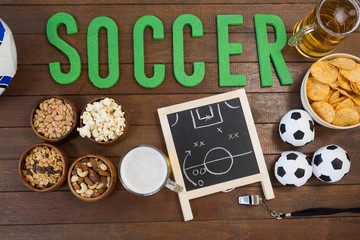 Strategy board, snacks and football on artificial grass