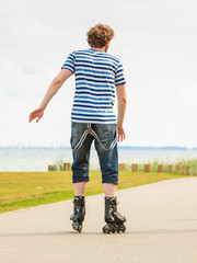 Fototapeta premium Young man rollerblading outdoor on sunny day