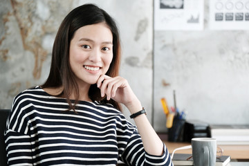 Young asia woman smiling while sitting at working desk, happy emotion, working at home, office life, business casual lifestyle