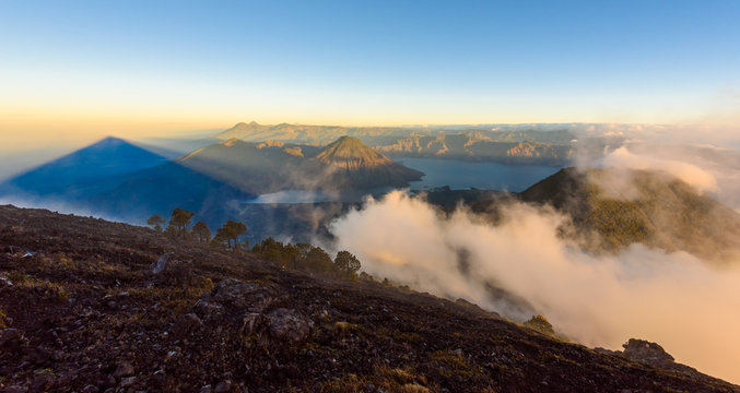Panorama view of Lake Atitlan and volcano San Pedro early in the morning from peak of volcano Atitlan, Guatemala