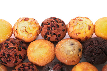 Muffin chocolate chip cup cake or cupcake various flavor several lots many in a row line border isolated on white background photo