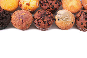 Muffin chocolate chip cup cake or cupcake various flavor several lots many in a row line border isolated on white background photo