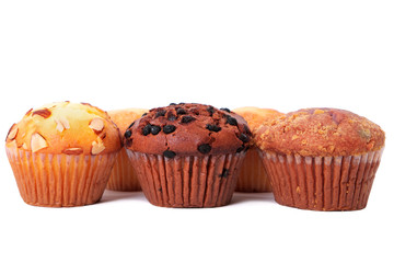 Muffin chocolate chip cup cake or cupcake various flavor several lots many ina row line isolated on white background photo
