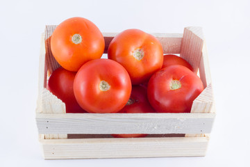 a small crate with tomatoes