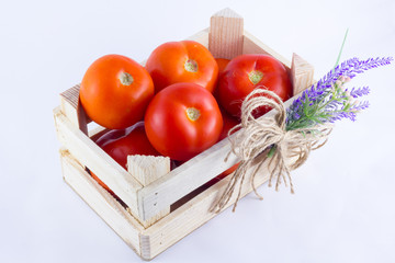 a small crate with tomatoes