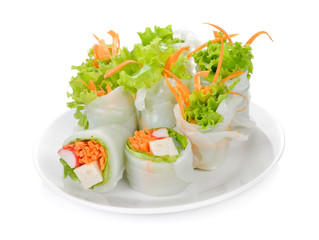 Fresh vegetable salad roll in noodle tube on dish isolated on white background