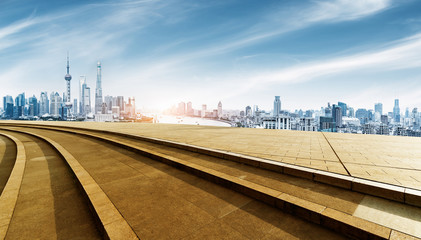 Fototapeta premium empty brick floor and cityscape of shanghai in blue sky