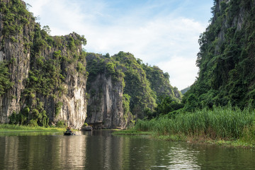 View of limestone mountain in valley with tourist cruising at evening