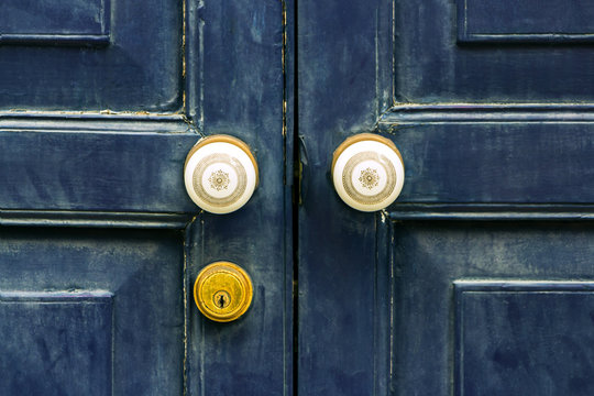 The door made of hardwood with ornate knobs and keyhole.