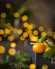 Christmas  tangerine mood!) Fresh tangerines on a wooden vintage background with lights. The best celebration background. Winter xmas holidays concept.
