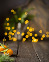 Christmas  tangerine mood!) Fresh tangerines on a wooden vintage background with lights. The best celebration background. Winter xmas holidays concept.