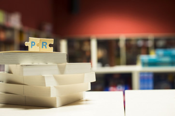 PR letters. Word PR on books in bookstore.