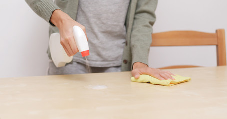 Housewife clean table in living room