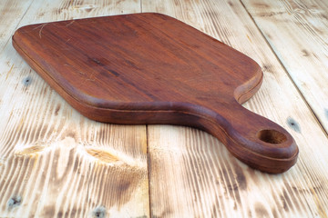 Wooden cutting board on wood pine