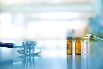 stethoscope for doctor analysis with drug vial and syringe in science laboratory  