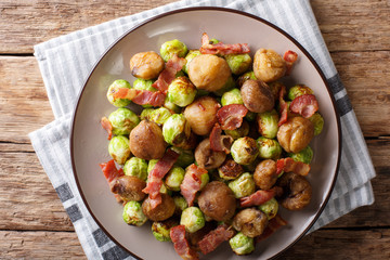 Delicious appetizer: roasted chestnuts, Brussels sprouts and bacon close-up. Horizontal top view