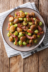 Fried chestnuts, brussels sprouts and bacon closeup. Vertical top view