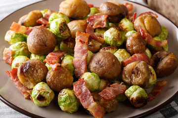 salad of chestnuts, brussels cabbage and bacon close-up on a plate. horizontal