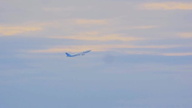 passenger plane takes off against the sky at slow motion