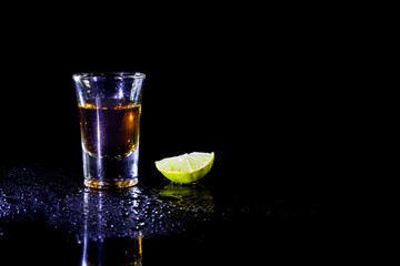 Whiskey in glass shots  and lemon.