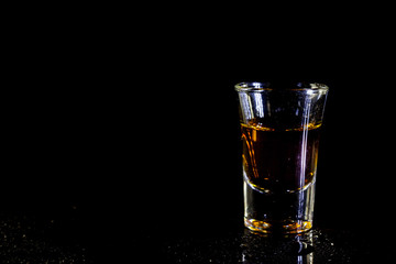 Whiskey in glass shots  on black background.