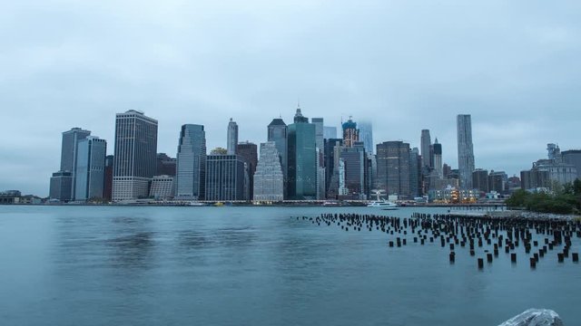 NY, USA – Timelapse of Manhattan skyline at sunset with Brooklyn Bridge and Hudson River in view