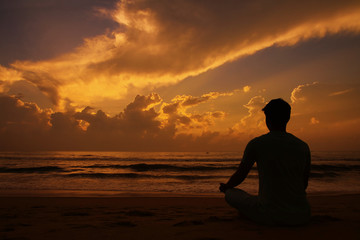  Yoga and meditation. Silhouette of Young man