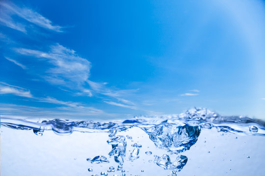 Water And Air Bubbles Under Sky Background.