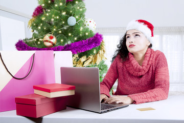 Fototapeta na wymiar Indian woman buying Christmas gifts online