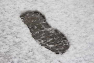 Human footprint in fresh, cold, wet and soft snow