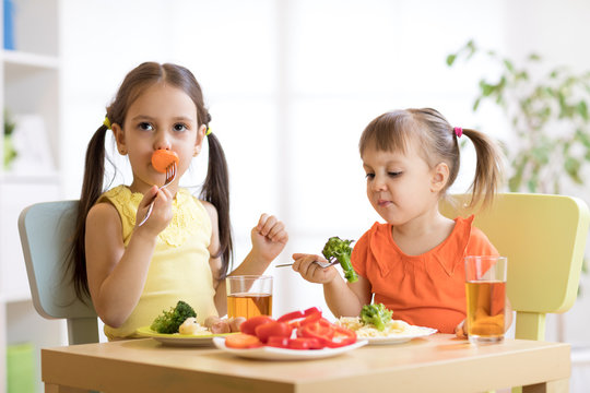 Little discontented children does not want to eat pasta with vegetables
