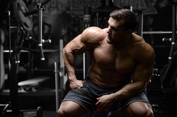 Fototapeta na wymiar Brutal strong bodybuilder athletic men pumping up muscles with dumbbells.