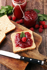 Fresh raspberry jam with toast or bread for breakfast.