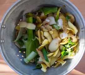 colander with potato and leek peelings