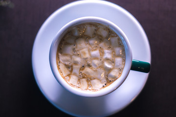 Coffee in cafe with marshmallow with blurred background.