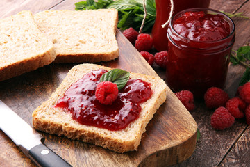 Fresh raspberry jam with toast or bread for breakfast.