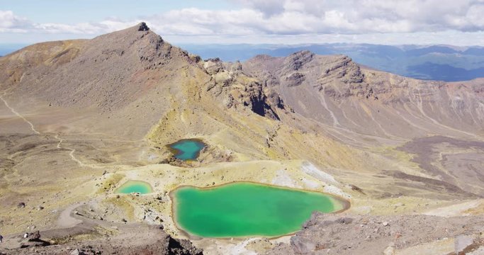 Spectacular landscape of the Emerald Lakes in Tongariro Alpine Crossing. Stunning volcanic landscape against cloudy sky. It is one of the famous tourist attractions of New Zealand.