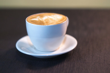 A cup of coffee with a picture in a cafe.