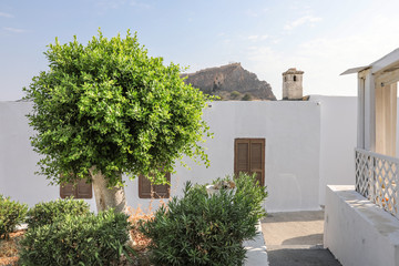 narrow medieval streets of white houses in Lindos, Rhodes Island, Greece. Legend has it that the village was set up by one of the divine sons of Zeus. 