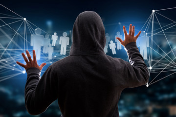 Hacker man in the dark using computer to hack data and information system