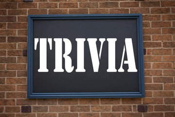 Obraz premium Conceptual hand writing text caption inspiration showing Trivia. Business concept for Unimportant Quiz Fun written on announcement road sign with background and copy space