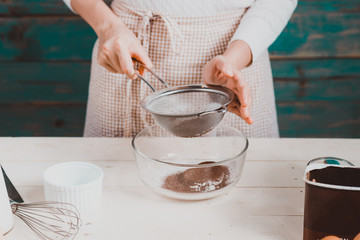 House wife wearing apron making. Steps of making cooking chocolate cake.