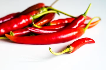 Fotobehang Red hot peppers fresh on the kitchen table. White background. © Piotr