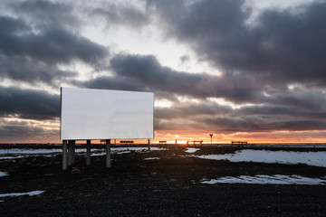 Blank billboard with dark sunset in winter at countryside