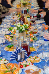 The people at the Banquet. A solemn event in the enterprise. Anniversary or wedding. Snacks and alcohol on the tables. Served buffet style. Catering.