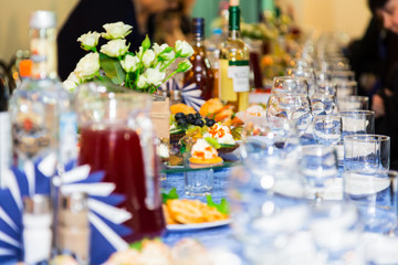 The people at the Banquet. A solemn event in the enterprise. Anniversary or wedding. Snacks and alcohol on the tables. Served buffet style. Catering.