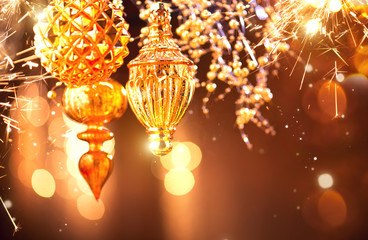 Christmas and New Year golden decorations closeup. Abstract blinking holiday background