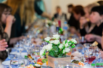 The people at the Banquet. A solemn event in the enterprise. Anniversary or wedding. Snacks and alcohol on the tables. Served buffet style. Catering.
